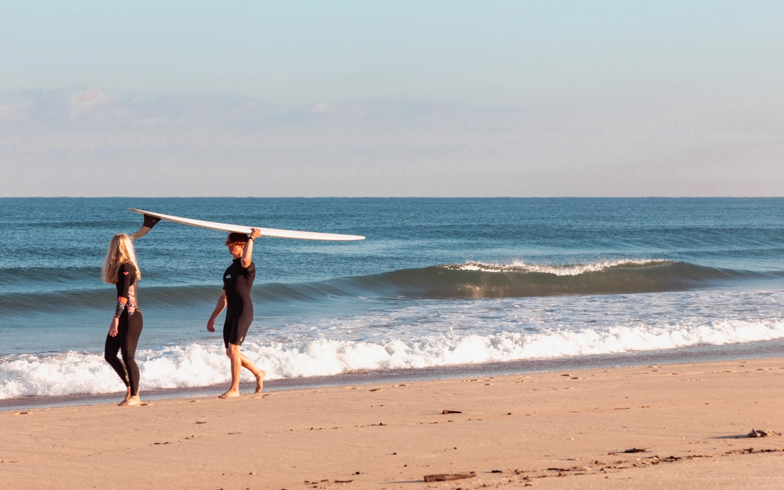 Surfer in a wetsuit on the beach