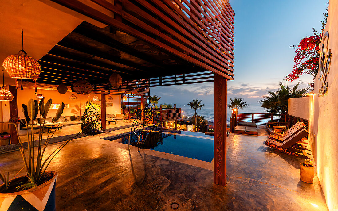 At night, the pool area shines in a cozy, warm glow.
