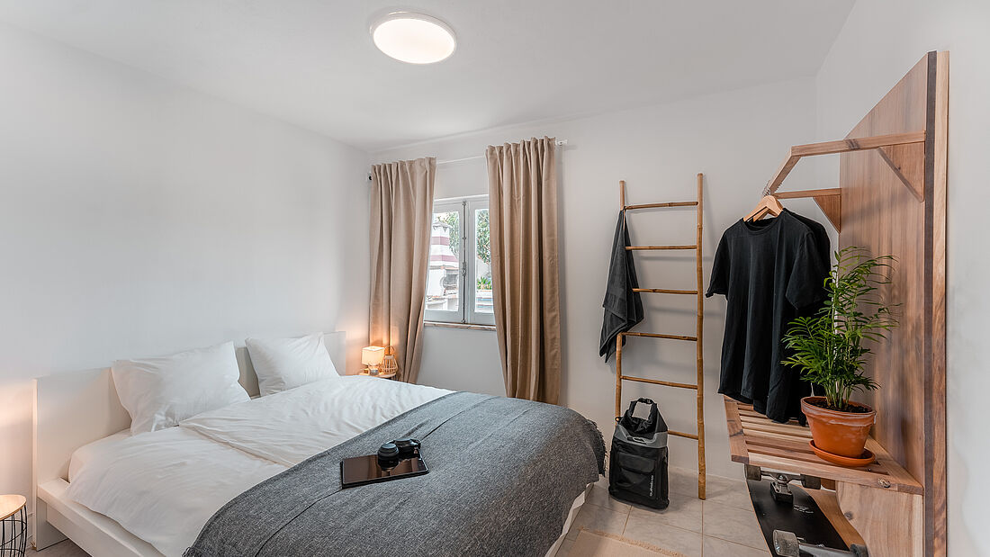 Cozy bedroom with a large bed pure surf camp peniche portugal apartment