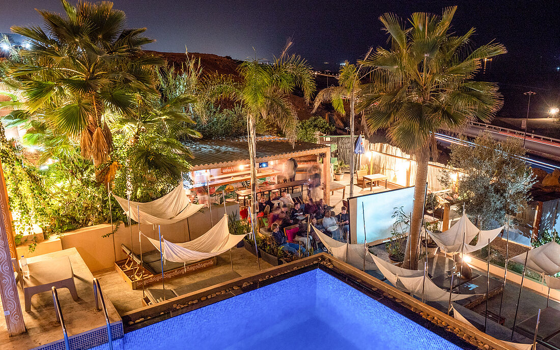 Enjoy movie night in the garden beside the pool.