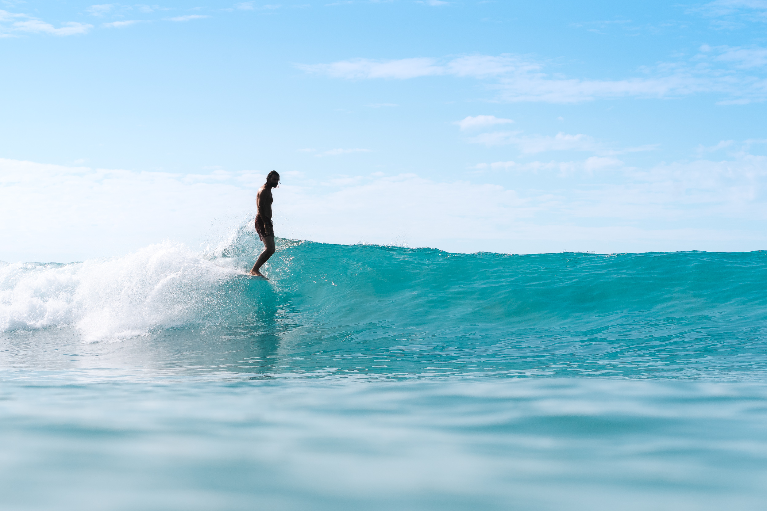 Hang ten in a perfect wave on a sunny day